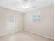 Bright bedroom featuring tile floors and two windows at 4457 Brooksdale Dr, Sarasota, FL 34232