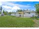 Large backyard with patio, shade sail and grassy area at 4457 Brooksdale Dr, Sarasota, FL 34232