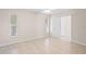 Bright bedroom with tile floors, double closets, and neutral walls at 4457 Brooksdale Dr, Sarasota, FL 34232