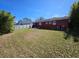 Large backyard with grassy area and patio at 4727 W Wisconsin Ave, Tampa, FL 33616