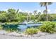 Serene pond with fountain, surrounded by tropical plants at 4873 Village Gardens Dr # 191, Sarasota, FL 34234