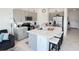 Spacious kitchen featuring gray cabinets, a large island, and stainless steel appliances at 5655 Archipelago St, Nokomis, FL 34275