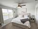 Main bedroom with large window, ceiling fan, and neutral color palette at 5655 Archipelago St, Nokomis, FL 34275