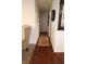 Long hallway with wood-look floors and area rug at 5949 W 17Th St # A35, Bradenton, FL 34207