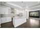 Modern kitchen with white cabinets, granite island, and stainless steel appliances at 805 Molly Cir, Sarasota, FL 34232
