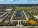 Aerial view of a residential community with a scenic pond surrounded by well-maintained landscaping at 805 Molly Cir, Sarasota, FL 34232