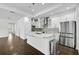 Modern kitchen with white cabinets, granite island, and stainless steel appliances at 805 Molly Cir, Sarasota, FL 34232