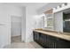 Bathroom featuring double sinks, modern lighting, and a separate toilet room at 805 Molly Cir, Sarasota, FL 34232