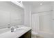 Clean bathroom with single sink vanity, large mirror, and bathtub with white tile surround at 805 Molly Cir, Sarasota, FL 34232