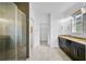 Bright bathroom with a double vanity, glass shower, and tile floors at 805 Molly Cir, Sarasota, FL 34232