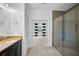 Stylish bathroom featuring glass-enclosed shower, single sink vanity, and bedroom access at 805 Molly Cir, Sarasota, FL 34232