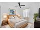 Bright bedroom featuring ceiling fan, neutral walls, wood accents, and minimalist style at 805 Molly Cir, Sarasota, FL 34232