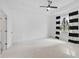 Spacious bedroom features plush carpeting, a modern ceiling fan, neutral walls, and natural light at 805 Molly Cir, Sarasota, FL 34232