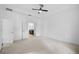Bright primary bedroom features plush carpet, ceiling fan, neutral walls, and en-suite bathroom at 805 Molly Cir, Sarasota, FL 34232