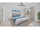 Bright bedroom featuring plush carpet, ceiling fan, tray ceiling, neutral walls, and stylish decor at 805 Molly Cir, Sarasota, FL 34232
