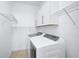 Well-lit laundry room with modern washer and dryer and ample storage at 805 Molly Cir, Sarasota, FL 34232