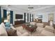 Spacious living room with hardwood floors, modern furniture, and large windows with blue drapes at 805 Molly Cir, Sarasota, FL 34232