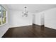 Bright living room with dark wood floors and a modern chandelier at 805 Molly Cir, Sarasota, FL 34232