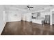 Open-concept living space showcasing hardwood floors, modern lighting, and a view of the kitchen at 805 Molly Cir, Sarasota, FL 34232