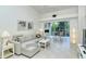Comfortable living room with sectional sofa and access to balcony at 9489 Millbank Dr # 2625, Sarasota, FL 34238