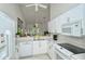 Bright kitchen with white cabinets, modern appliances, and a breakfast bar at 9489 Millbank Dr # 2625, Sarasota, FL 34238