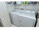 Convenient laundry room with washer, dryer, and storage shelves at 9489 Millbank Dr # 2625, Sarasota, FL 34238
