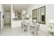Bright dining area with glass table and seating for four, adjacent to kitchen at 9489 Millbank Dr # 2625, Sarasota, FL 34238