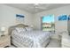 Comfortable main bedroom with a king-size bed and access to a balcony at 9489 Millbank Dr # 2625, Sarasota, FL 34238