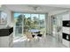 Sunroom with table and chairs, offering tranquil garden views at 9489 Millbank Dr # 2625, Sarasota, FL 34238