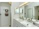 Modern bathroom with double vanity, large mirror, and shower at 9489 Millbank Dr # 2625, Sarasota, FL 34238