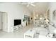 Open living room, kitchen, and dining area with high ceilings at 9489 Millbank Dr # 2625, Sarasota, FL 34238