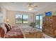 Main bedroom with king bed, balcony access, and ample closet space at 1100 Capri Isles Blvd # 523, Venice, FL 34292