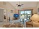 Comfortable living room features vaulted ceilings, sliding doors to lanai at 1100 Capri Isles Blvd # 523, Venice, FL 34292