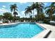 Community pool with surrounding lounge chairs at 1100 Capri Isles Blvd # 523, Venice, FL 34292