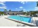 Community pool with lounge chairs and patio area at 1100 Capri Isles Blvd # 523, Venice, FL 34292