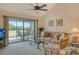 Relaxing living room with access to lanai and golf course views at 1100 Capri Isles Blvd # 523, Venice, FL 34292