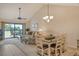Combined living and dining area with vaulted ceiling and access to lanai at 1100 Capri Isles Blvd # 523, Venice, FL 34292