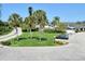 Landscaped grounds with palm trees and parking area at 1100 Capri Isles Blvd # 523, Venice, FL 34292