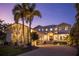 Stunning two-story home with a brick driveway and palm trees at 1243 Starboard Ln, Sarasota, FL 34242