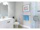 Bathroom featuring a modern vanity, toilet, a framed art piece, and tiled walk-in shower with glass door at 1243 Starboard Ln, Sarasota, FL 34242