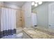 Bathroom with tub, shower, granite vanity, updated fixtures, and a soft color scheme at 1243 Starboard Ln, Sarasota, FL 34242