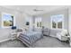 Bright bedroom featuring dual windows, a stylish bed, and modern furnishings under recessed lighting at 1243 Starboard Ln, Sarasota, FL 34242