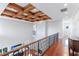 Upstairs hallway with wood floors, decorative ceiling, and wrought iron railing at 1243 Starboard Ln, Sarasota, FL 34242