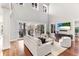 Spacious living room with wood floors, a soaring ceiling, lots of natural light, and sliding doors to the outdoor area at 1243 Starboard Ln, Sarasota, FL 34242