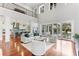 Open-concept living room with soaring ceilings, wood floors, lots of natural light, and views into the kitchen at 1243 Starboard Ln, Sarasota, FL 34242
