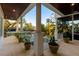 An outdoor patio area with plants, overlooking a water view and lush landscaping at 1243 Starboard Ln, Sarasota, FL 34242
