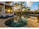 Backyard pool featuring lounge chairs and tropical foliage, overlooking the waterfront at 1243 Starboard Ln, Sarasota, FL 34242