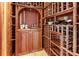 Custom wood wine cellar with wooden racks to showcase a collection with a display area and storage at 1243 Starboard Ln, Sarasota, FL 34242