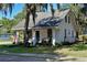 Charming white cottage with a front porch and landscaped yard at 1318 6Th W St, Palmetto, FL 34221