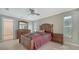Bedroom with wood bed frame and window with blinds at 134 Da Vinci Dr, Nokomis, FL 34275